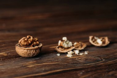 walnuts in nut shells as dementia symbol on wooden table  clipart