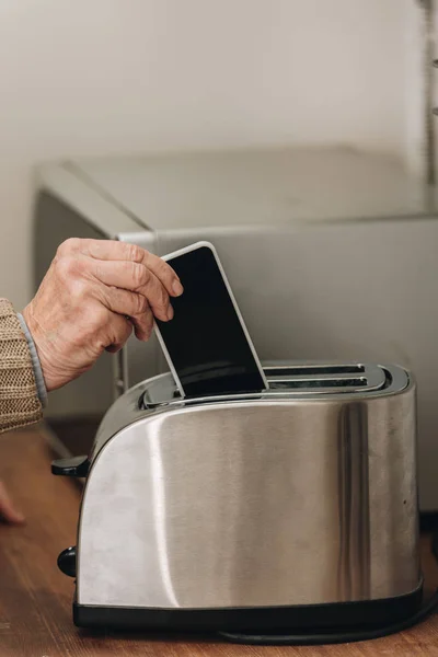 Cropped View Senior Man Putting Smartphone Toaster — Stock Photo, Image