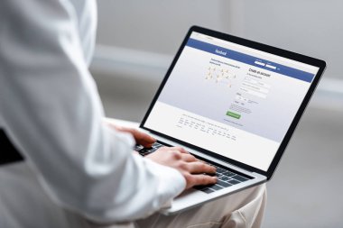 Kırpılan görünümünü ekran web sitesi facebook ile dizüstü bilgisayar kullanan kadın