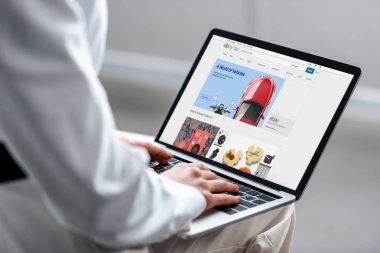cropped view of woman using laptop with ebay website on screen clipart