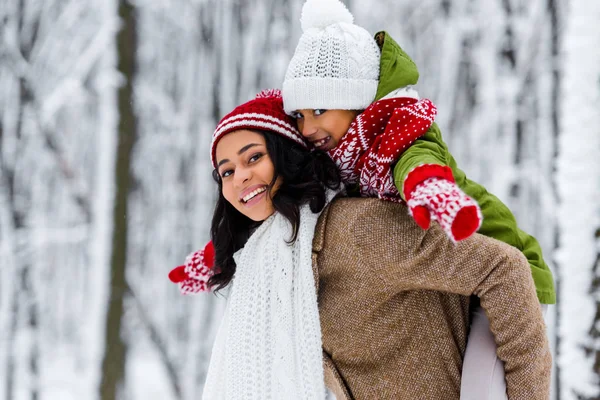 Attractive African American Mother Giving Piggyback Ride Cute Daughter Winter — Stock Photo, Image