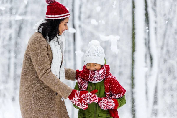 Cheerful African American Mom Hugging Cute Child Closed Eyes Snowfall — Stock Photo, Image