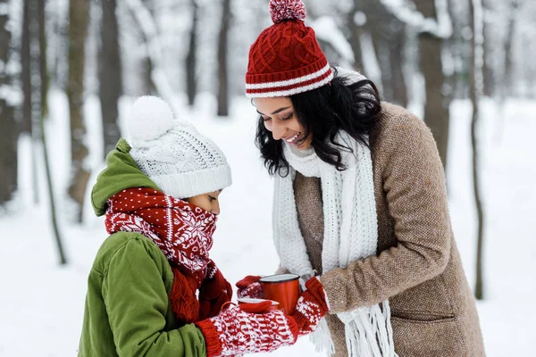 Attractive African American Mother Cute Daughter Holding Cups Tea Snowy — Stock Photo, Image