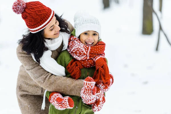 Attractive African American Mother Hugging Adorable Preteen Daughter Winter Forest — Stock Photo, Image