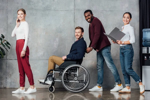 Smiling Multiethnic Group People Casual Clothes Rolling Man Wheelchair Waiting — Stock Photo, Image