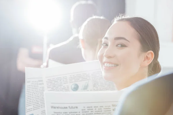 Selective Focus Asian Businesswoman Looking Camera Holding Newspaper Colleagues Background — Stock Photo, Image