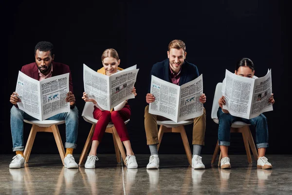 Multiethnic Group Casual Businesspeople Sitting Chairs Reading Business Newspapers Isolated — Stock Photo, Image