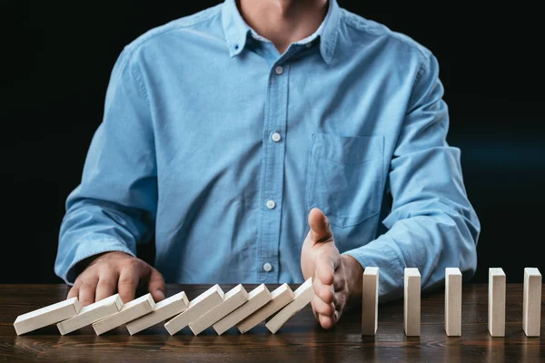 Partial View Man Sitting Desk Preventing Wooden Blocks Falling — Stock Photo, Image