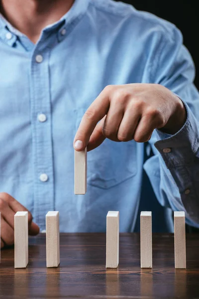 Cropped View Man Picking Wooden Brick Out Row Table — Stock Photo, Image