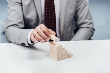 seçici odak üstünde Ahşap ahşap tuğla koyarak adamın Hıristiyanlıkla kariyer basamaklarını engeller