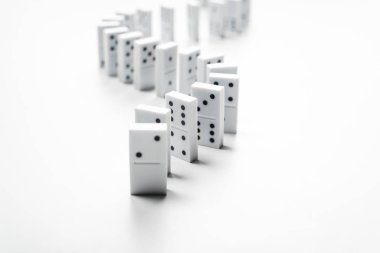 selective focus of domino row isolated on white with copy space clipart
