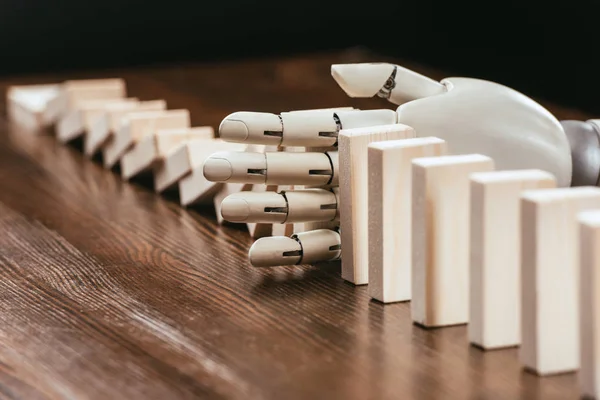 Selective Focus Robotic Hand Preventing Wooden Blocks Falling Desk — Stock Photo, Image