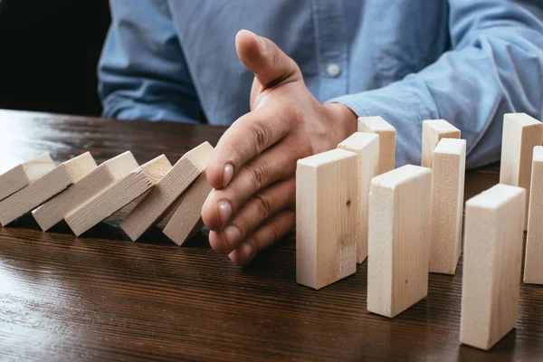 Cropped View Man Preventing Wooden Blocks Falling Desk — Stock Photo, Image