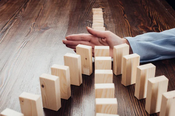 Selective Focus Woman Preventing Wooden Blocks Falling — Stock Photo, Image