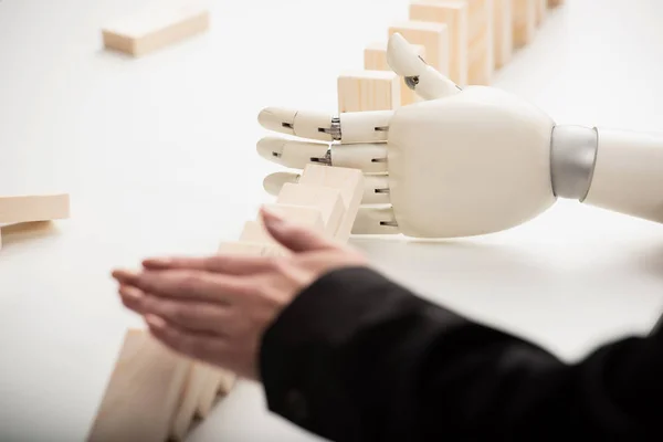 Cropped View Woman Pushing Wooden Bricks While Robotic Hand Preventing — Stock Photo, Image