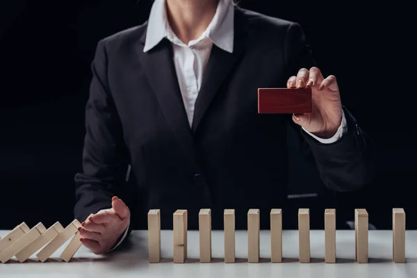 Cropped View Businesswoman Holding Red Brick Preventing Wooden Blocks Falling — Stock Photo, Image