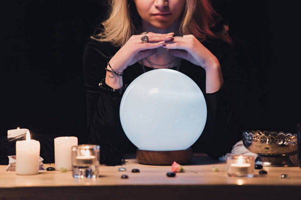 cropped view of female esoteric holding hands above fortune teller