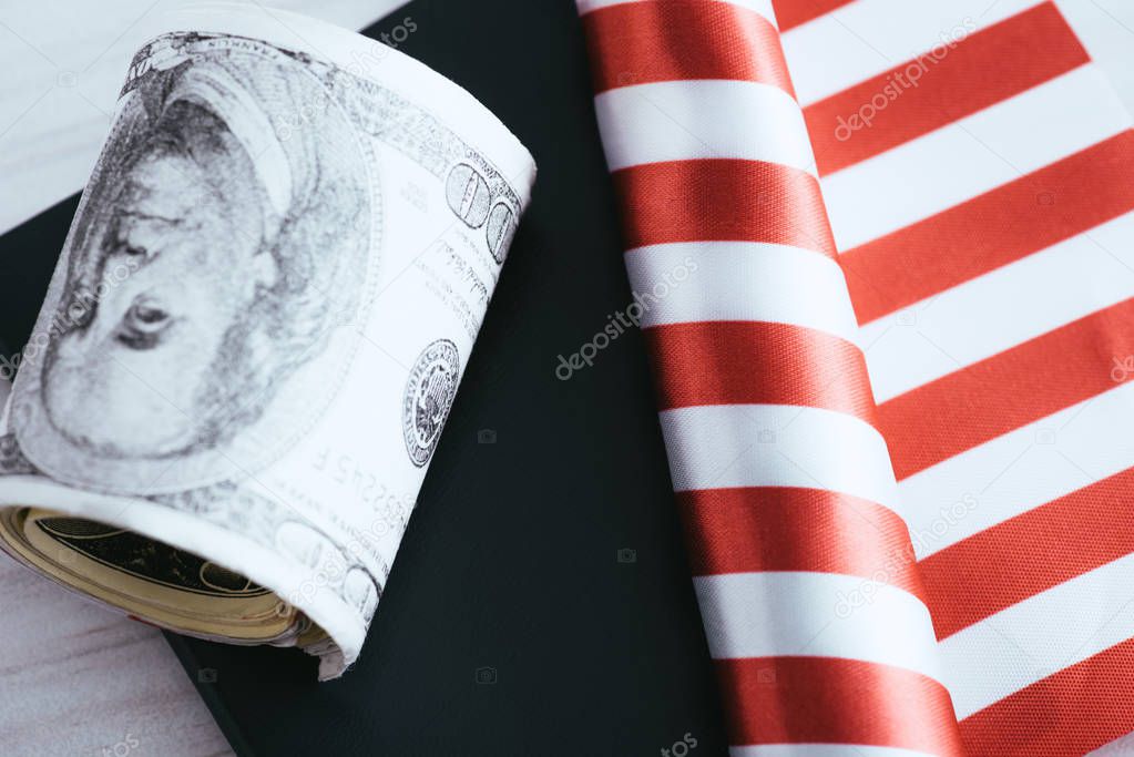 selective focus of striped roll near passport and dollar banknotes 