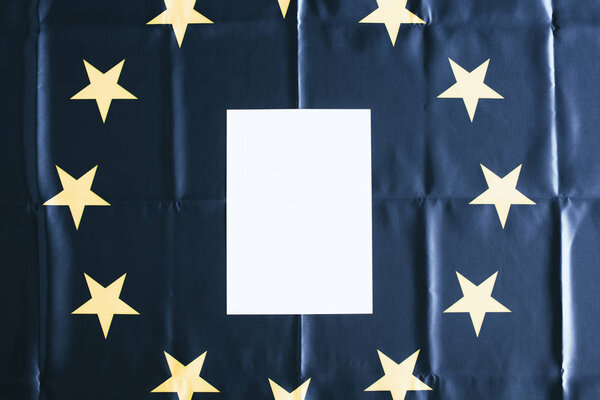 top view of white blank with copy space with european flag on background