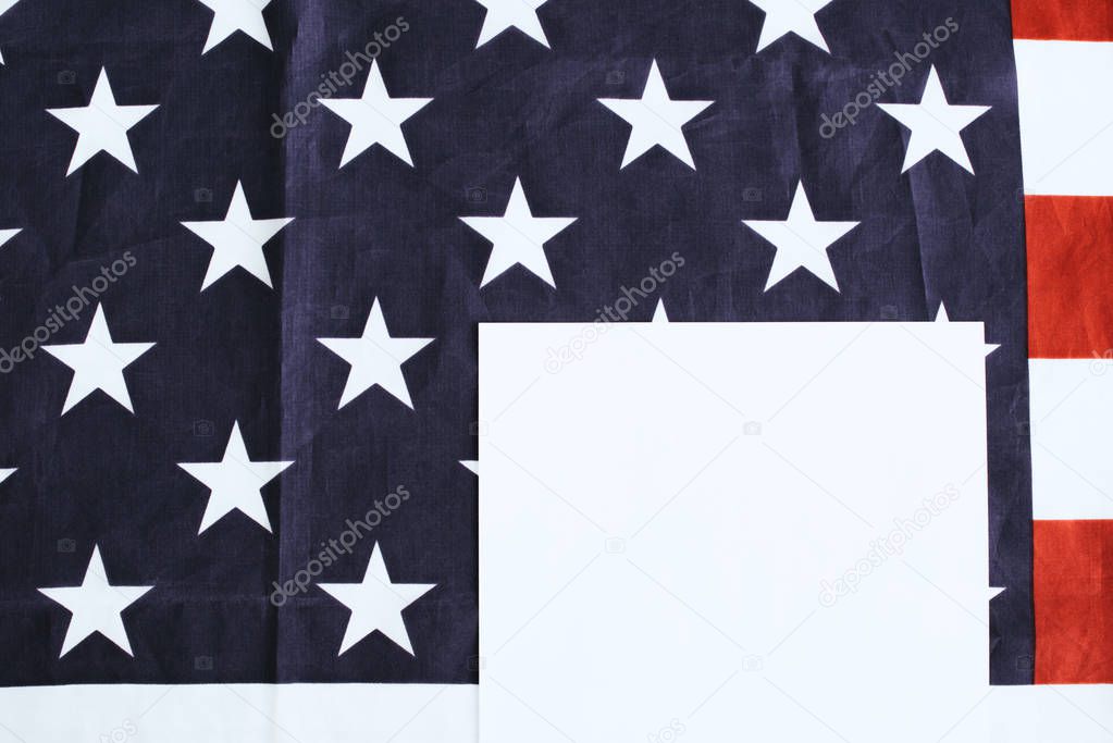 top view of paper on american flag with stras and stripes and paper with copy space