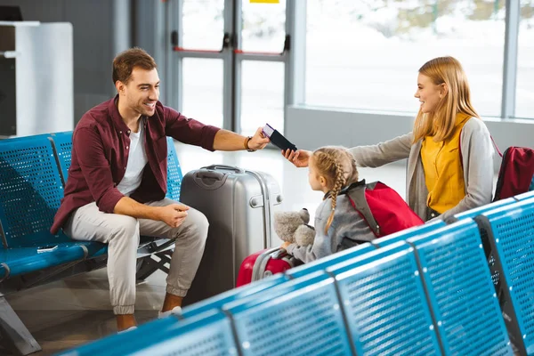 Happy Wife Sitting Daughter Giving Passports Air Tickets Husband Airport — Stock Photo, Image