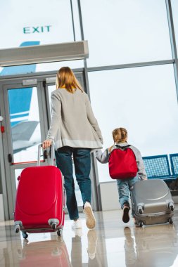 Anne ve kızı elele ve Bagaj, Havaalanı ile yürüme görünümünü geri 