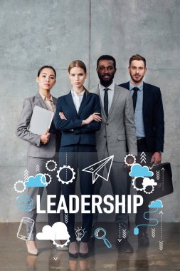 focused multiethnic group of businesspeople in formal wear posing and looking at camera with leadership illustration in front clipart