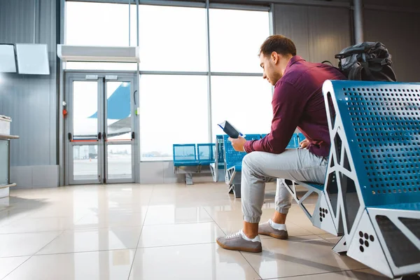 Man Holding Passport Air Ticket Sitting Gate Airport Departure Lounge — Stock Photo, Image