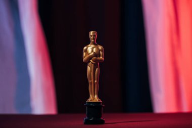 KYIV, UKRAINE - JANUARY 10, 2019: selective focus of golden oscar award on dark background clipart