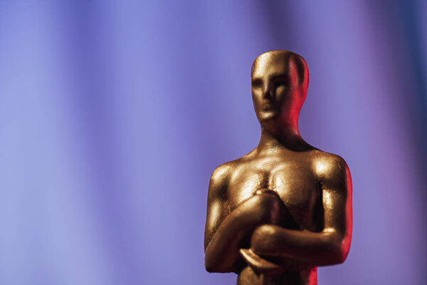 KYIV, UKRAINE - JANUARY 10, 2019: selective focus of golden oscar award on purple background with copy space