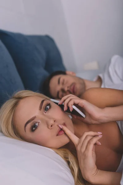 Young Woman Talking Smartphone Looking Camera Finger Lips While Boyfriend — Stock Photo, Image