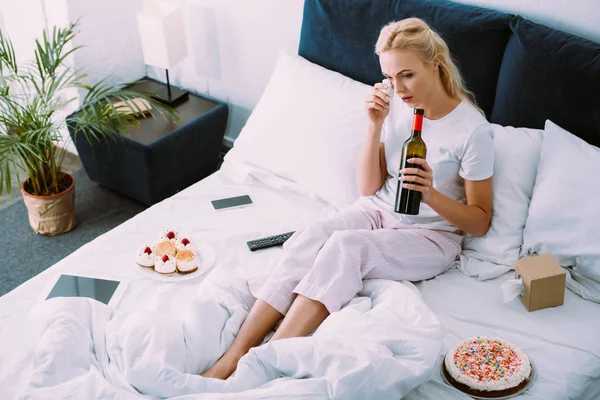 Upset Woman Bottle Wine Wiping Tears While Celebrating Birthday Bed — Stock Photo, Image