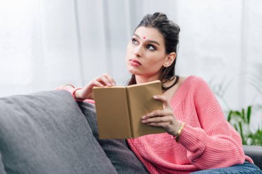 kitap okuma ve düşünme koltukta kız Hintli öğrenci