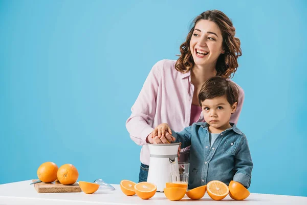 Happy Mother Cute Little Son Squeezing Juice Together Isolated Blue — Stock Photo, Image