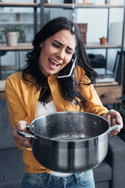 Irritated Woman Talking Smartphone Holding Pot Water Leaking Ceiling — Stock Photo, Image