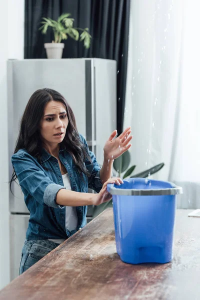 Worried Woman Using Bucket Leak Kitchen — Stock Photo, Image