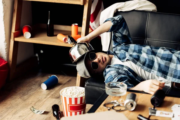 Handsome Man Holding Teapot Head While Lying Sofa Messy Living — Stock Photo, Image