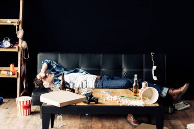 Partiden sonra evde kanepede yatan yorgun adam
