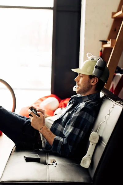 Cheerful Man Drinking Beer Helmet Playing Video Game Home — Stock Photo, Image