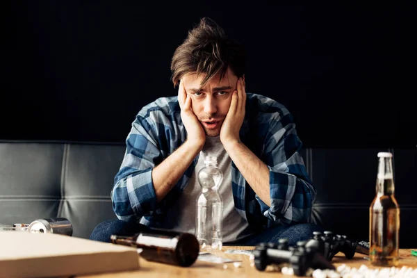 Man Suffering Hangover Holding Head Bottles Home — Stock Photo, Image