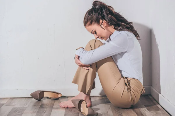 Sad Woman White Blouse Beige Pants Sitting Floor Head Bent — Stock Photo, Image