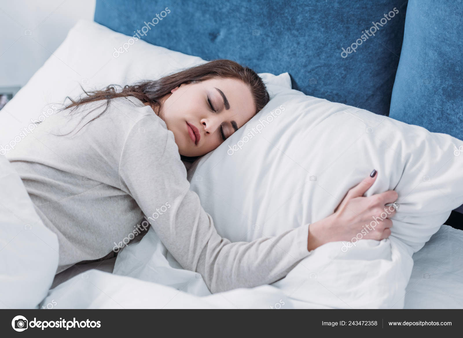 Girl hugging pillow while sleeping online