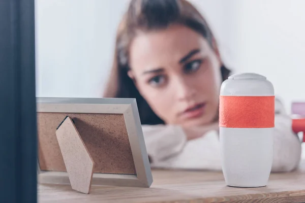 Selective Focus Picture Frame Funeral Urn Upset Woman Background — Stock Photo, Image