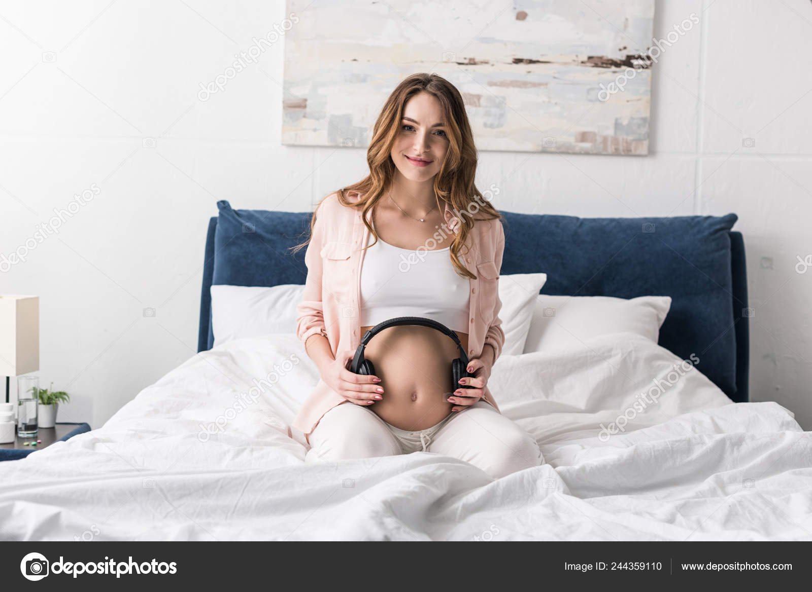 Curly Pregnant Woman Sitting Bed Headphones Belly Stock Photo by  ©AndrewLozovyi 244359110