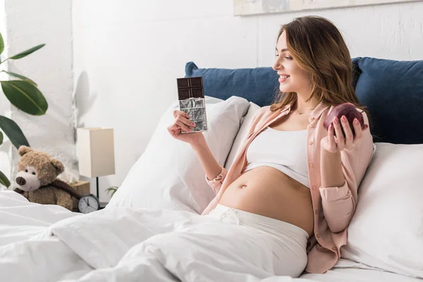 Relaxed Pregnant Woman Bed Holding Chocolate Bar Apple — Stock Photo, Image