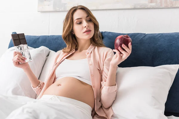 Pregnant Woman Holding Red Apple Chocolate Bar — Stock Photo, Image