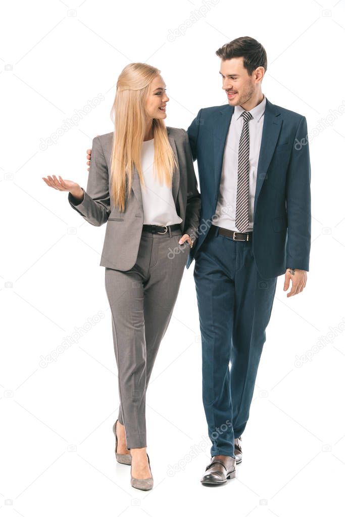 successful smiling businesspeople posing in suits isolated on white