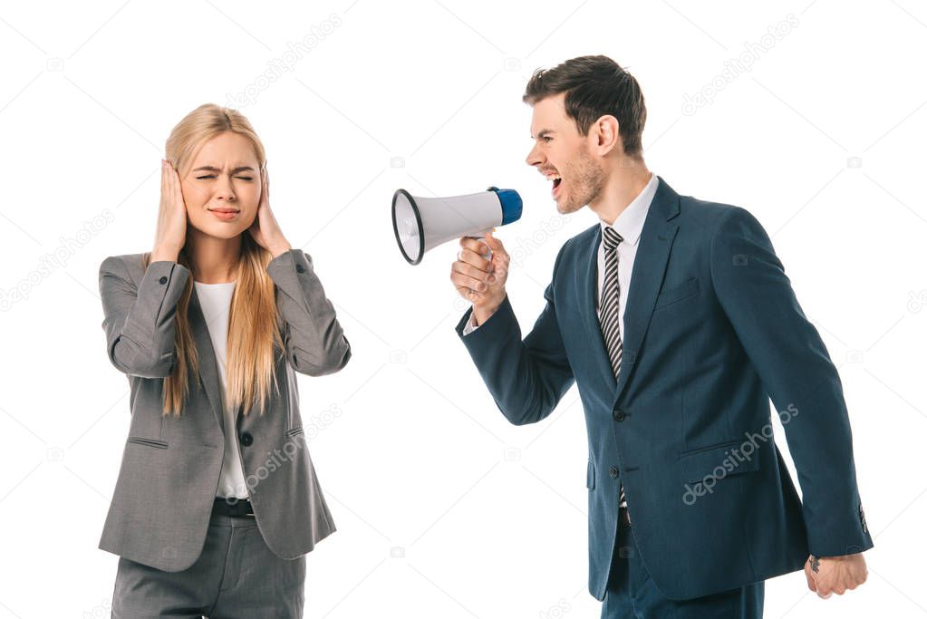 emotional businessman yelling into megaphone at frightened businesswoman isolated on white