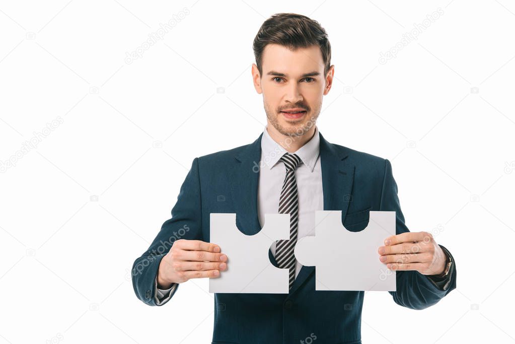 handsome businessman holding puzzle pieces isolated on white, business idea concept