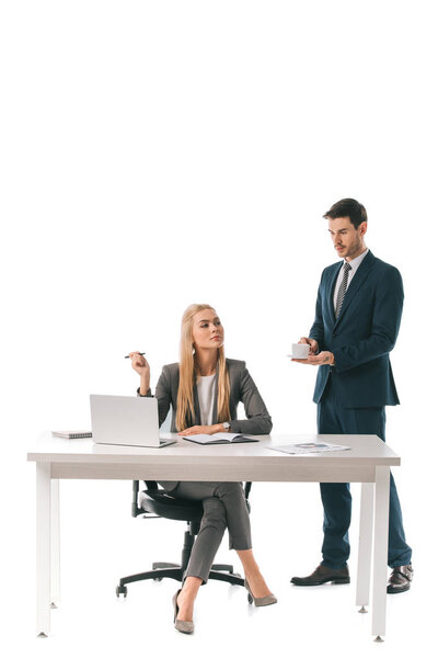 male secretary brought cup of coffee for successful businesswoman at workplace with laptop, isolated on white